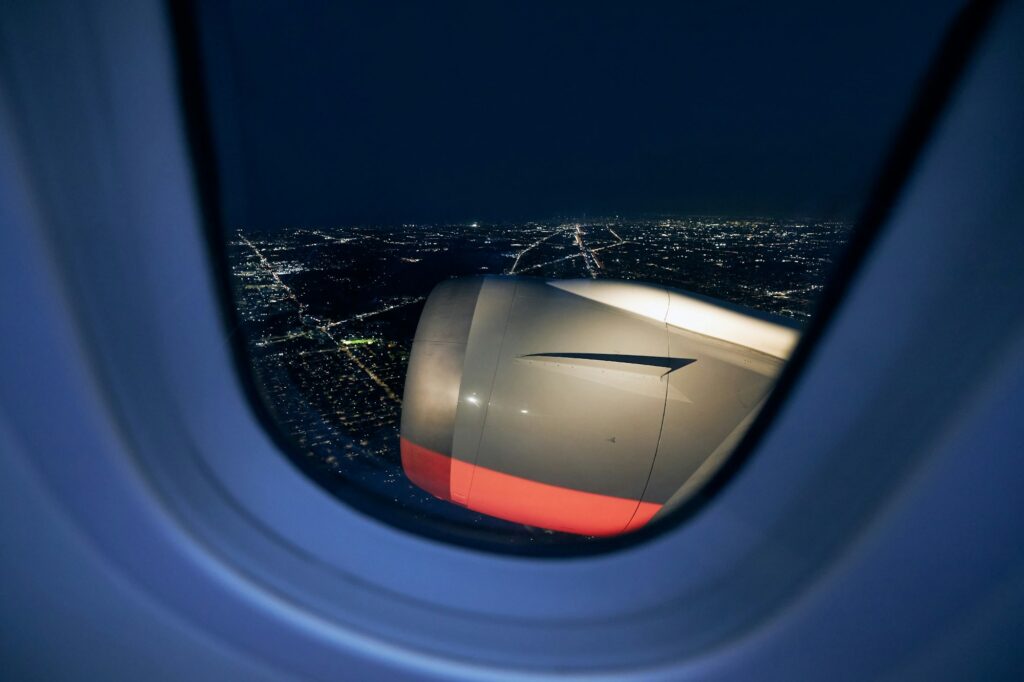 View from window of airplane at night, illustrating Emma's return from her video-editing trip to Milan